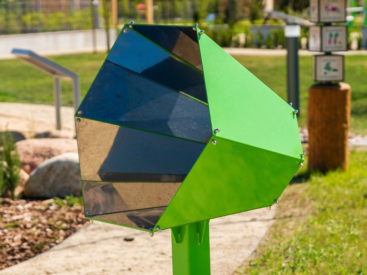The whole kaleidoscope: a green closed-profile steel frame standing on a lawn