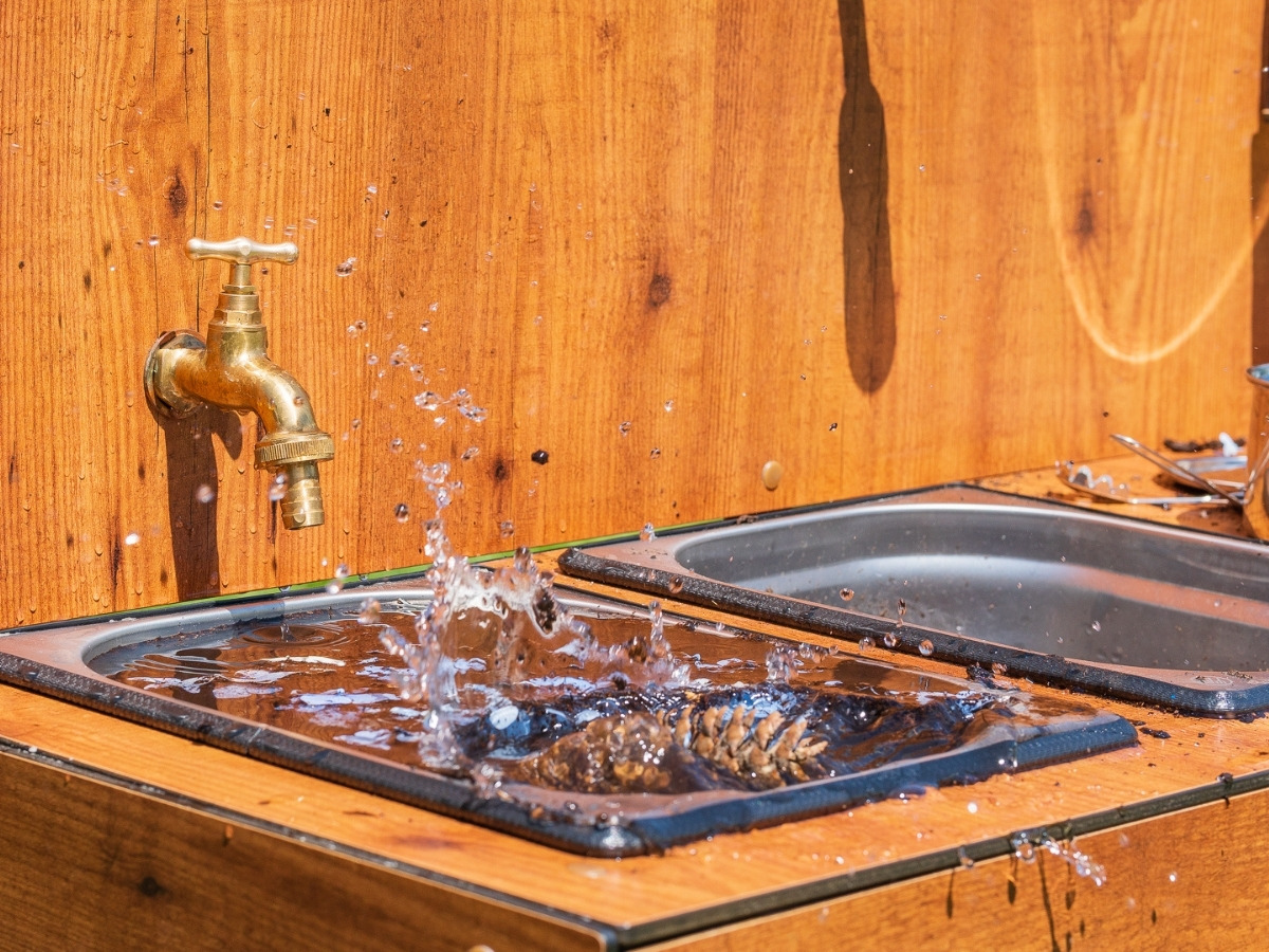 Two removable stainless steel basins set into the worktop, with a tap pouring water above them