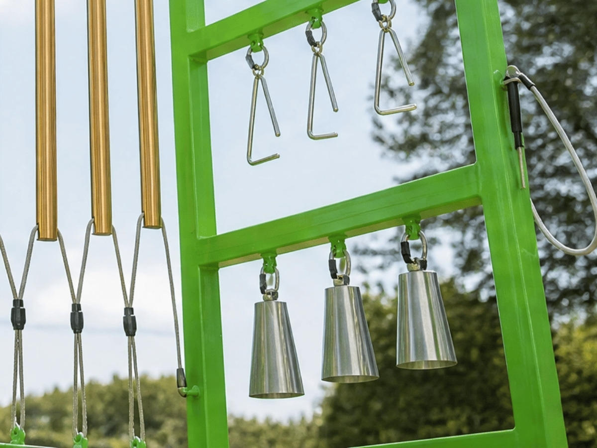 Small bells hanging in the frame of the musical panel, struck with a beater held by a child