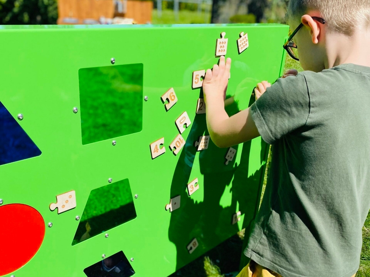 A child's finger tracing the edge of a geometric shape on the S09 Educational Board Pythagoras